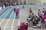 Watch: track official accidentally body checks high school relay runner